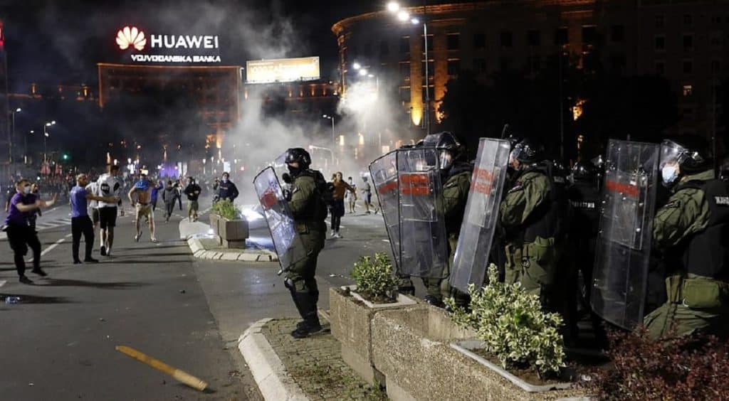 Serbian police officers clash with protesters