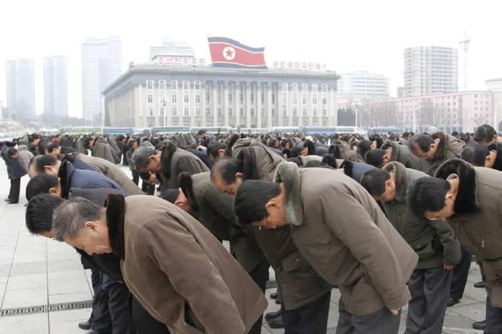 People bow to portraits of the late leaders, Kim Il Sung and Kim Jong Il, at the Kim Il Sung Square in Pyongyang, North Korea,